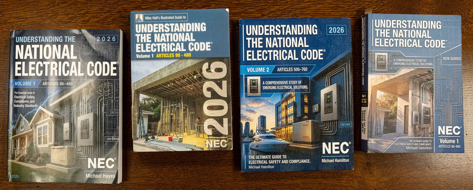 Four counterfeit copies of Understanding the National Electrical Code laid out on a wooden table